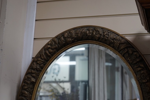 A gilt-framed oval mirror, width 66cm, height 78cm